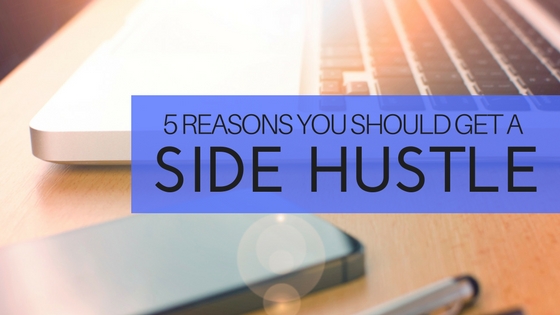 Laptop, cellphone, pens sitting on a desk, image used for Nicholas Fainlight blog on why you should get a side hustle