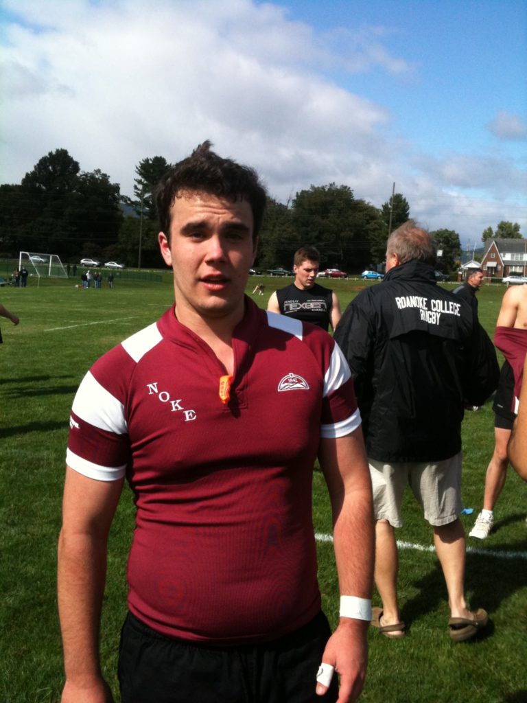 Nicholas Fainlight on the rugby field wearing a red jersey and facing the camera