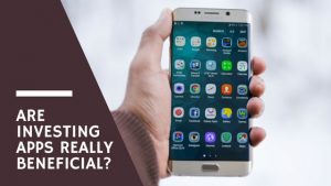 Person holding a phone with a bunch of apps on the screen, image used for Nicholas Fainlight blog on whether or not investing apps are worth it